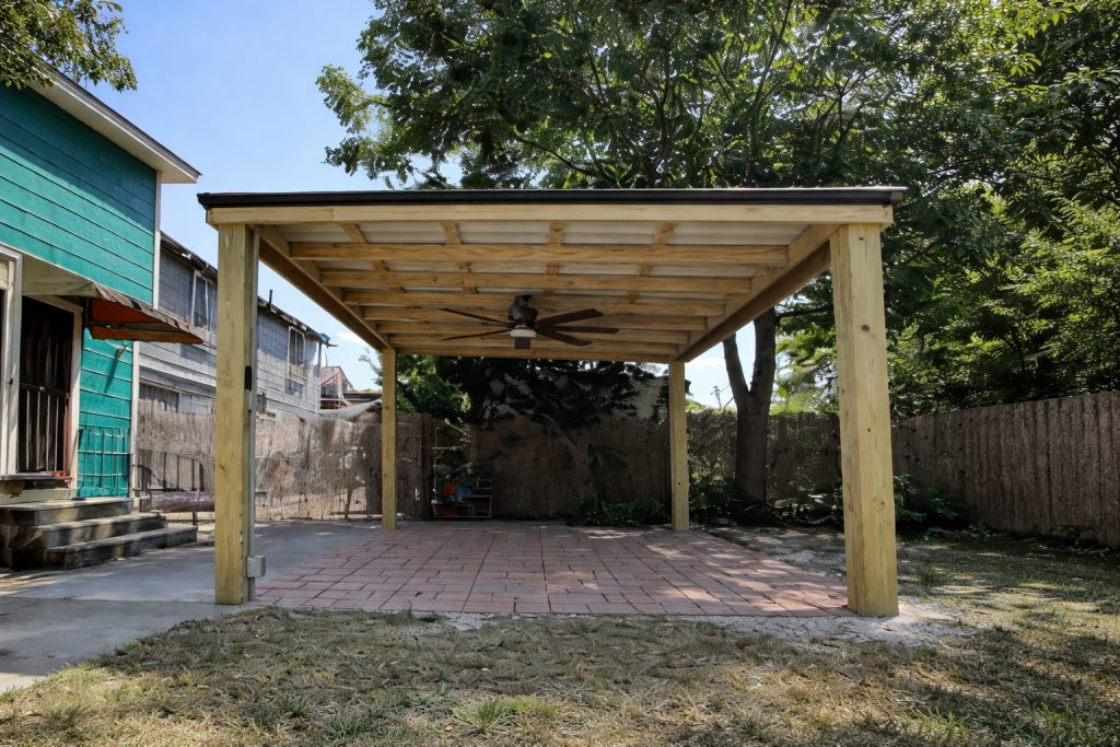 Custom covered freestanding wood pergola installed in Abita Springs, Louisiana, featuring a solid roof system and backyard patio coverage.