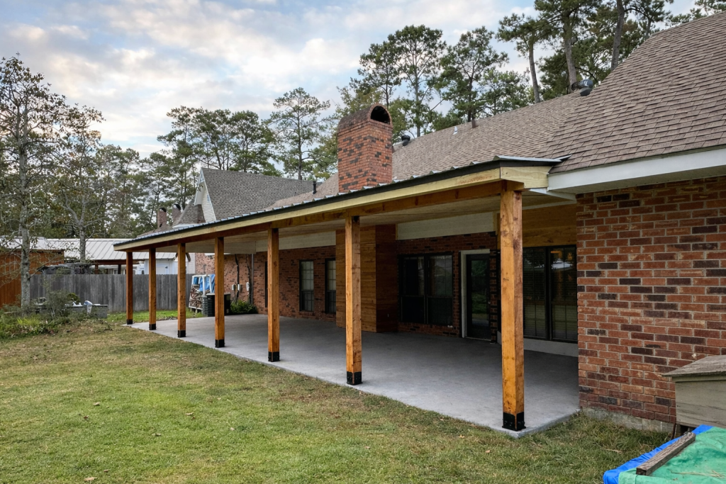 lean-to patio cover installation with cedar posts over backyard concrete patio at brick home in Mandeville Louisiana by GRC Outdoor Living