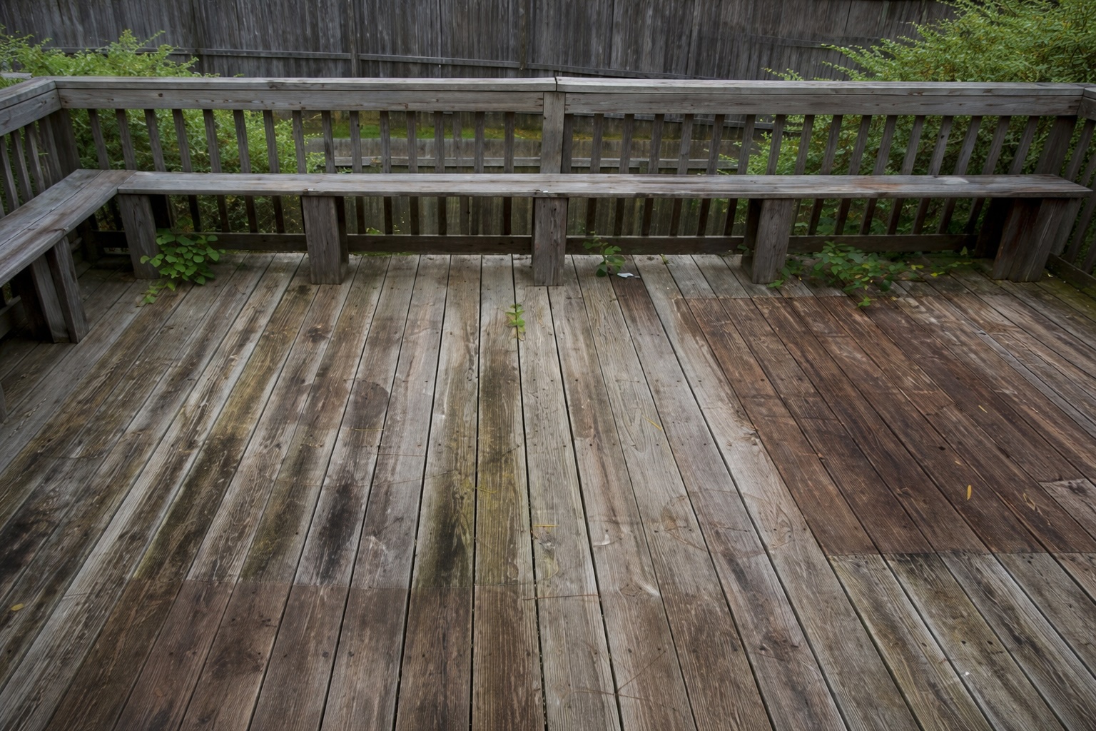 old weathered wood deck with discoloration and wear before replacement in covington louisiana