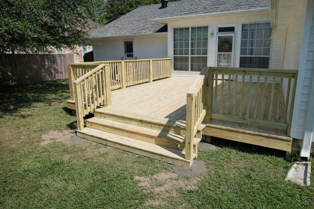 pressure treated pine deck installation with railing and steps in Covington Louisiana by GRC Outdoor Living
