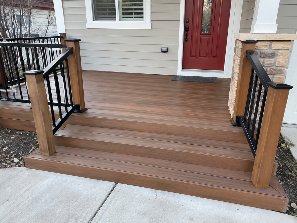 Custom entry landing deck with composite decking and black aluminum railings installed by GRC Outdoor Living in Covington Louisiana