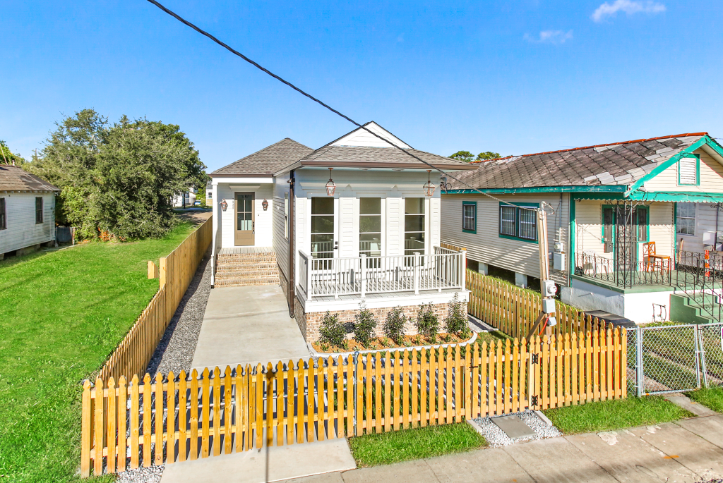 New pressure-treated pine semi-privacy fence with decorative front pickets and matching 6-foot privacy fence enclosing a residential property in New Orleans, Louisiana.